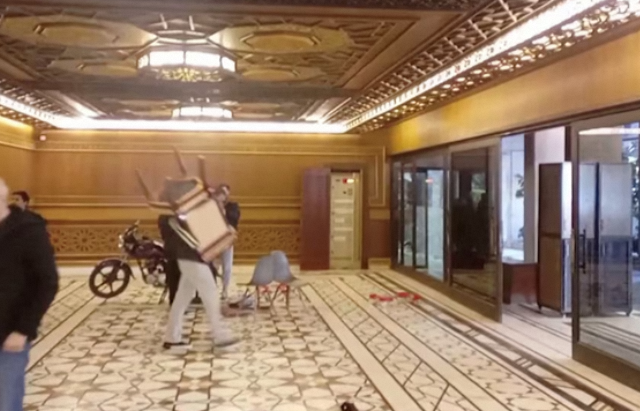 Syrians Invade Assad’s Palaces Amid Political Upheaval